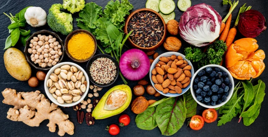 A selection of skin-friendly foods, including fresh vegetables, fruits, nuts, seeds, and spices, to help achieve radiant, healthy skin naturally.